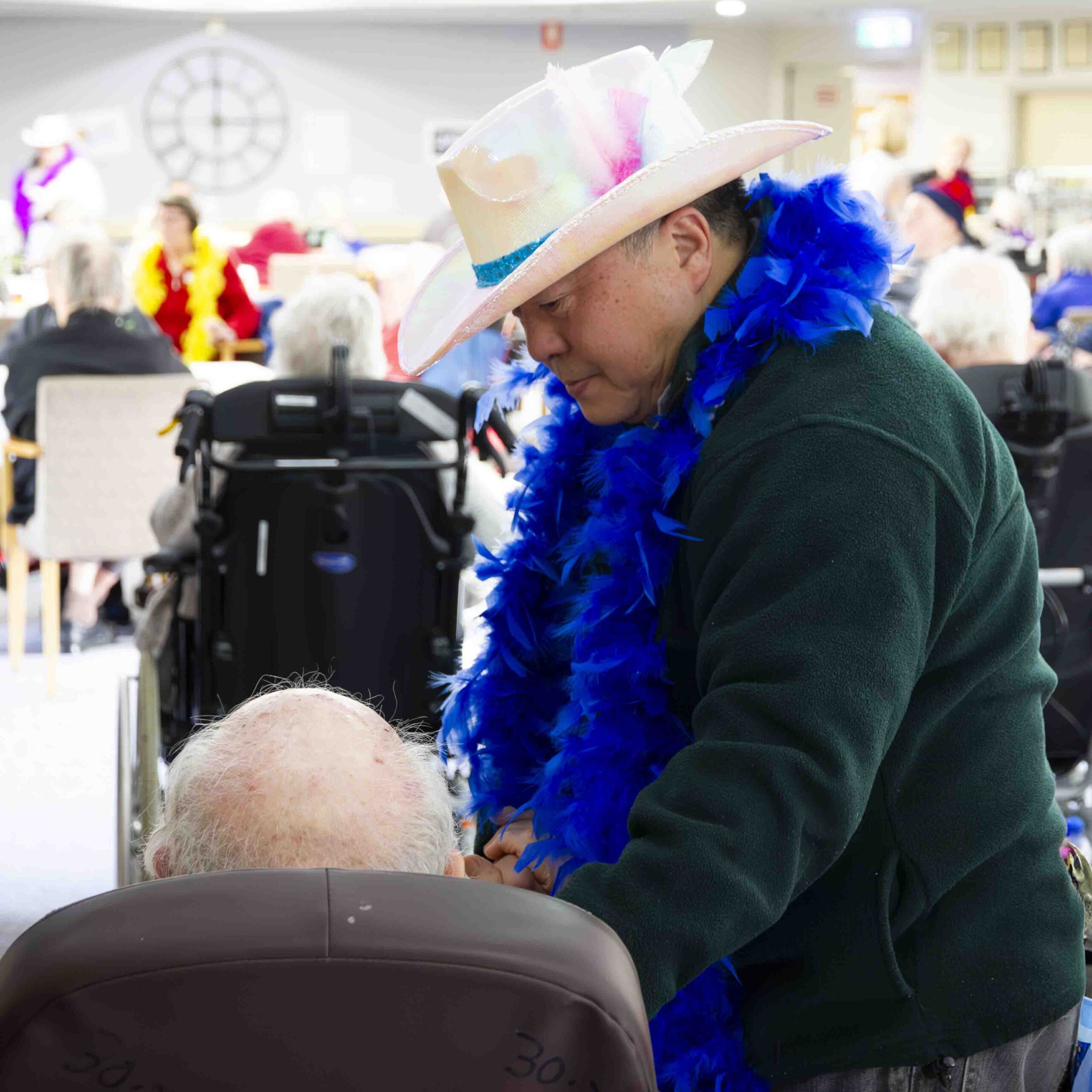 A man wearing a hat in a retirement home.