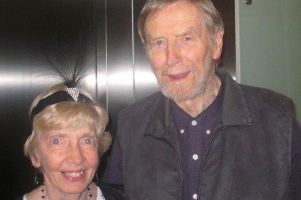 An elderly couple smiling for a photo.