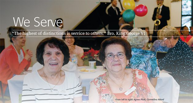 Two elderly women smiling at a social gathering with the quote "we serve - 'the highest of distinctions is service to others.' bro. king george vi" displayed above and a caption identifying the women by name below.