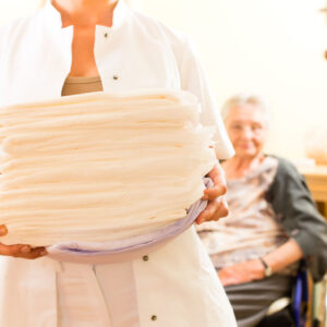 Young nurse and female senior in nursing home