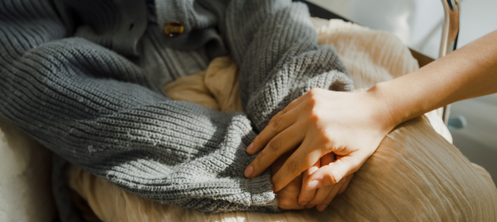 Closeup of young Asian people holding hands trust comfort help cancer patients talk crying stress relief in living room at home. Healthcare.