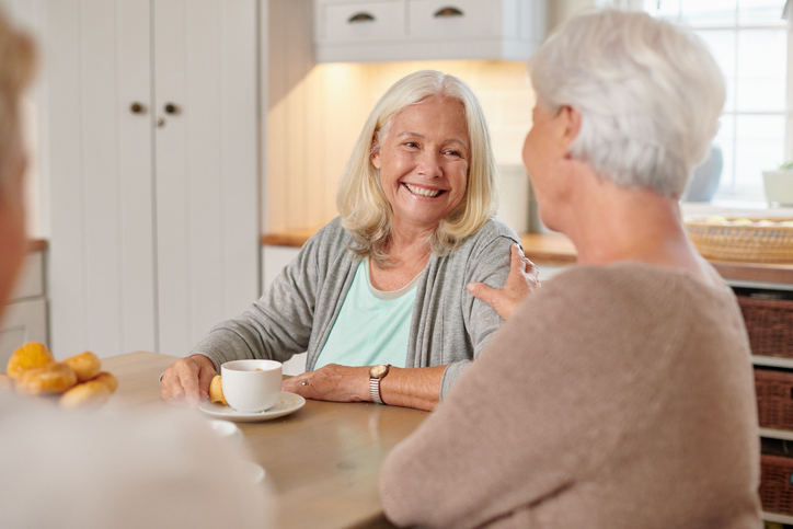 Shot of a senior group of women sitting together and bonding while enjoying tea and scones at home