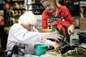 Royal Freemasons Mount Martha Valley resident Pam potting plants at Bunnings workshop