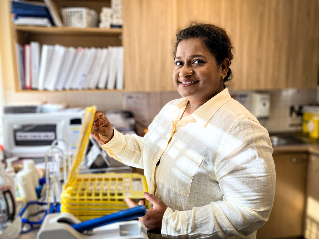 Lady in office holding medication chart