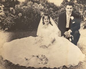 Old wedding photo showing the bride and groom in a garden setting