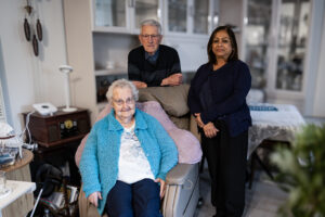Older married couple and friend in a living room