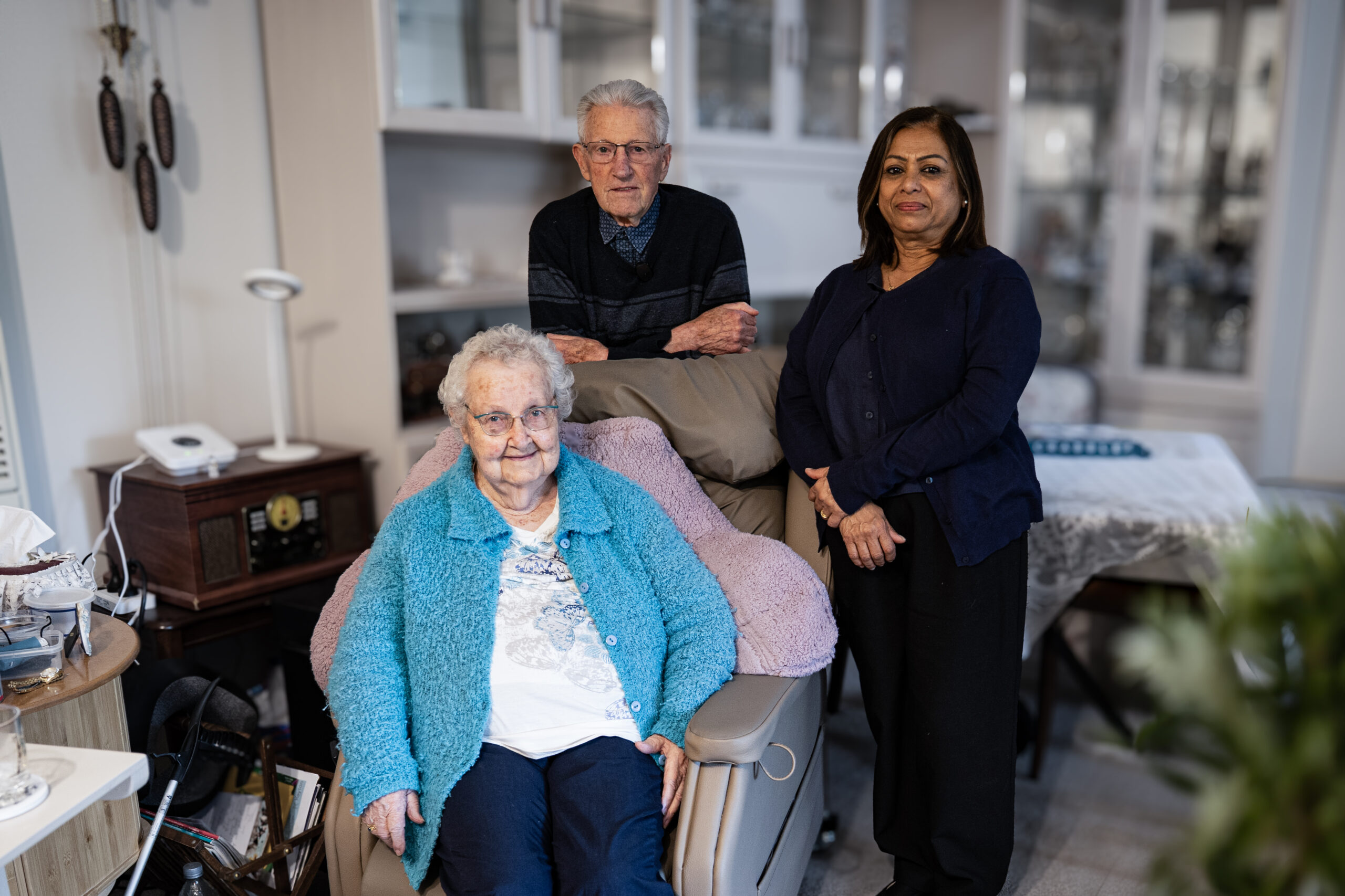 Older married couple and friend in a living room